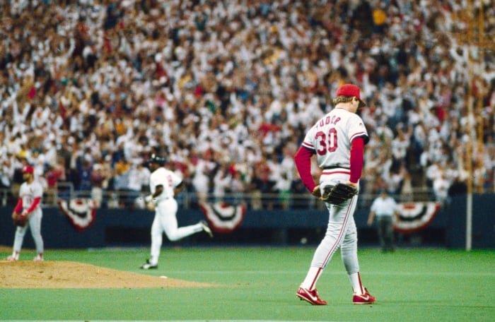 Cardinals pitcher John Tudor walks around the mound as a Twins player rounds the bases during the 1987 World Series